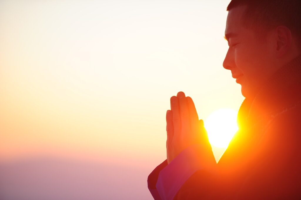 Person practicing gratitude and self-reflection by writing in a journal on Sunday evening